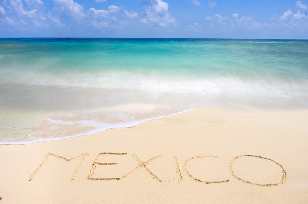 mexico written in sand Mexican tropical beach