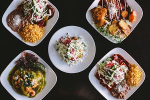 best mexican enchiladas on white plates