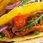 close up Mexican tacos with beef, corn and salsa.