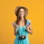 female tourist with mexico tourist card plane tickets and camera
