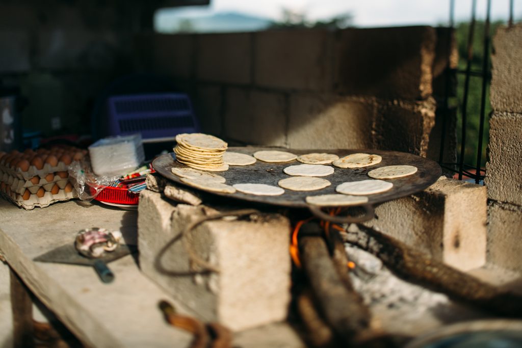homemade tortillas on camol over open fire