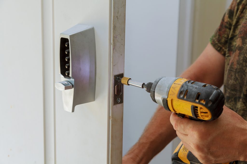 man installing door with smart lock