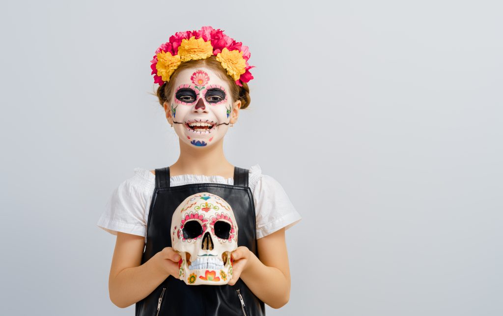 Mexican Day of the Dead child dressed for Mexico weather in december