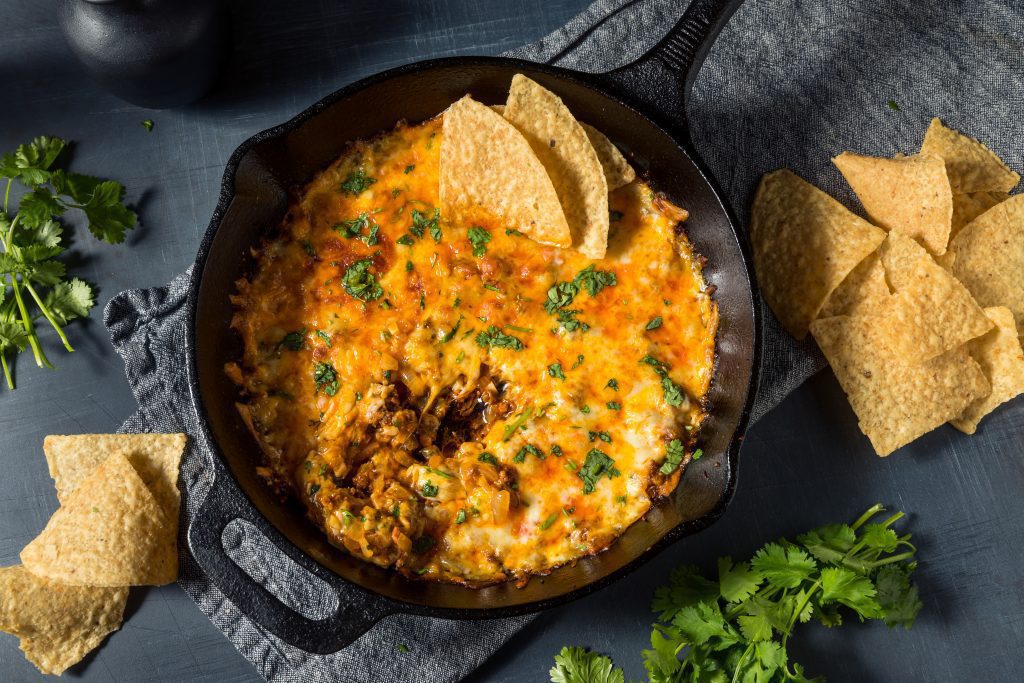 homemade Mexican Queso Dip on table with nachos