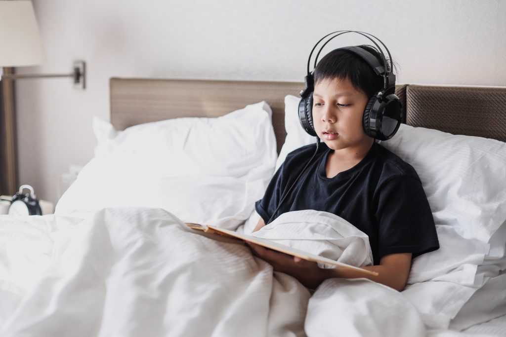 mexican boy learning with audible ebook