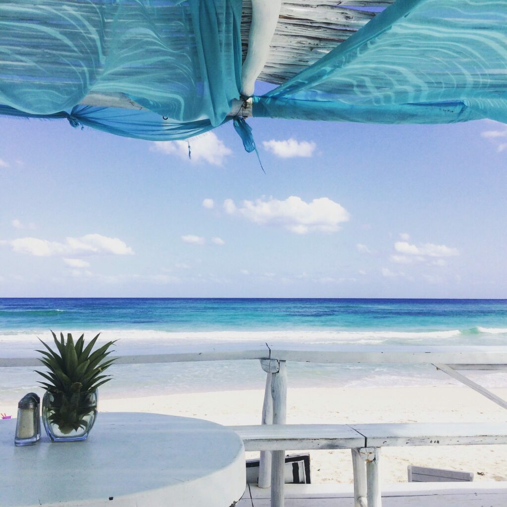 retirement at blue ocean with beach umbrella tulum mexico