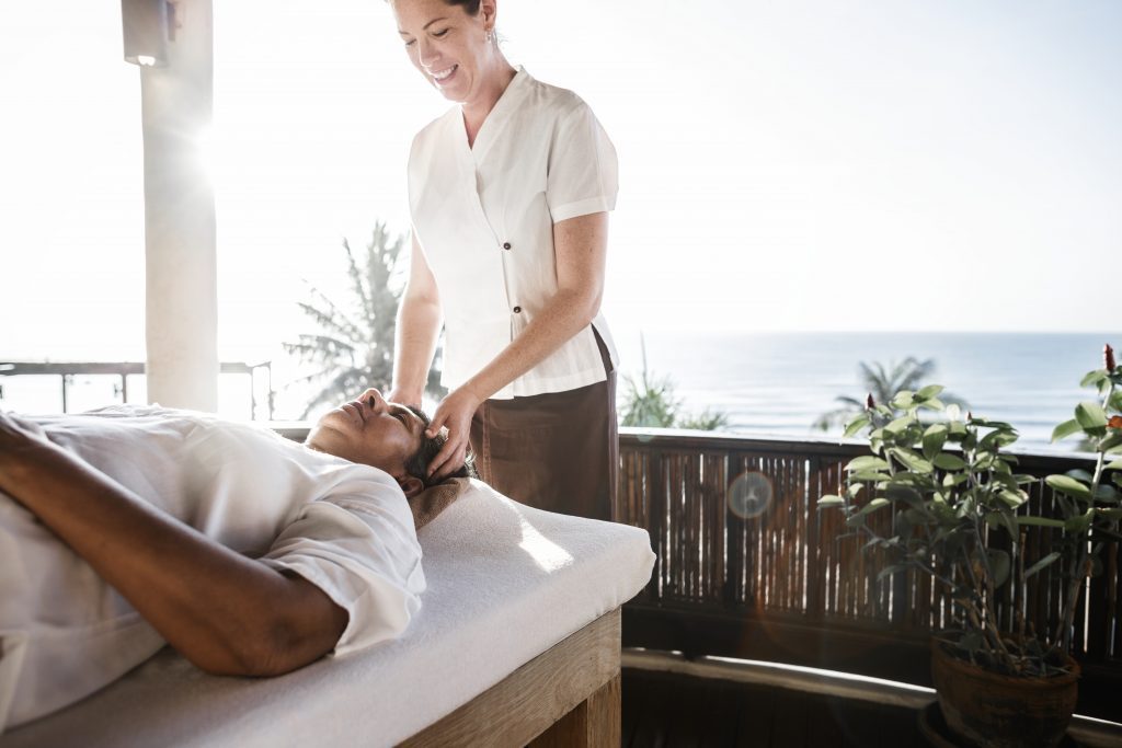 therapist giving massage at spa retreat in mexico