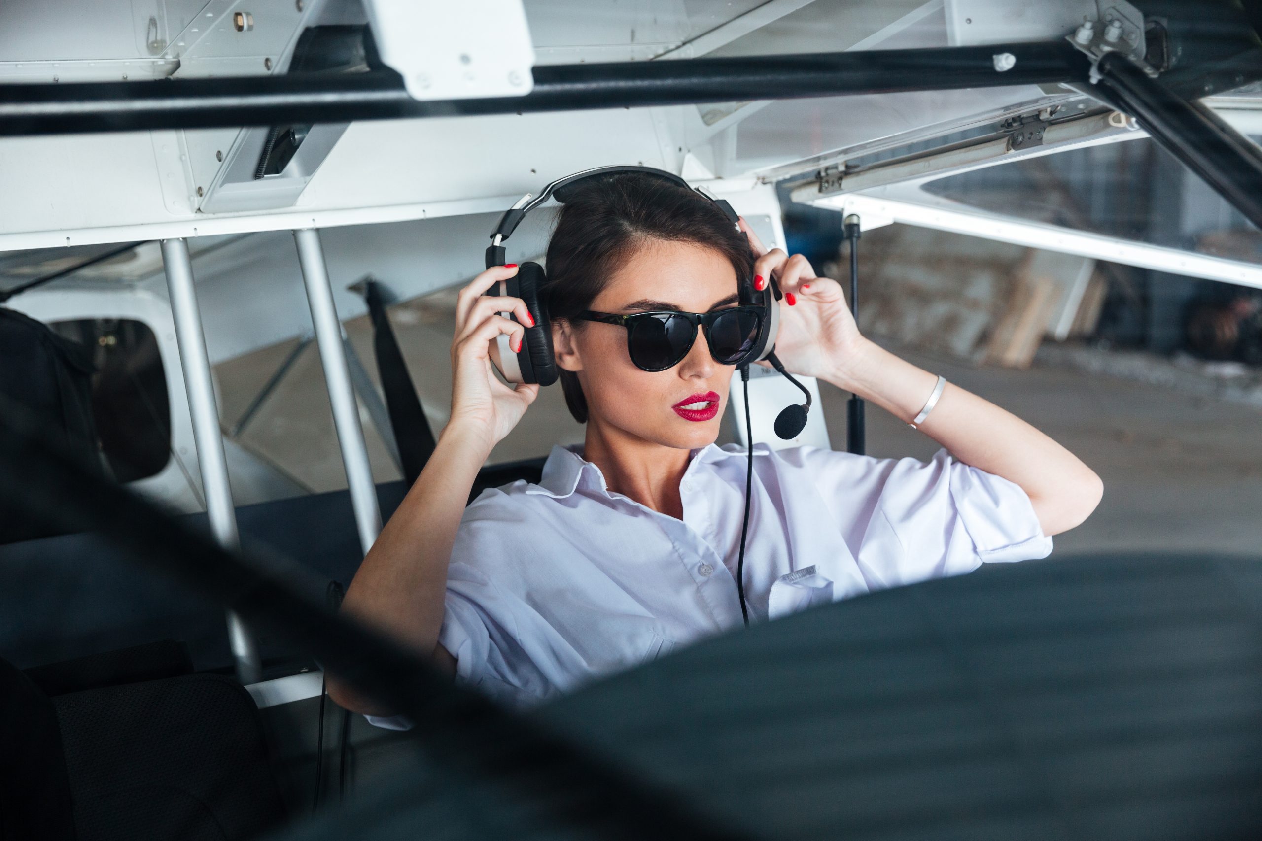 woman pilot in headset ready to fly in mexico airplane