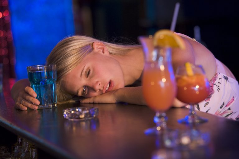 women resting head on mexico bar