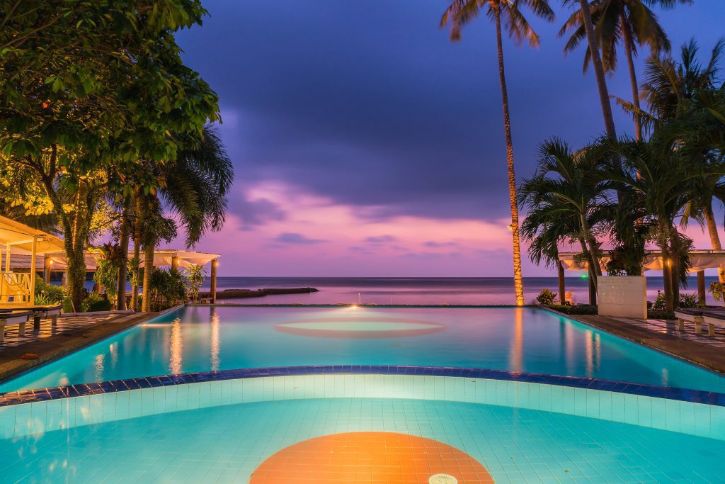 swimming pool at mexican adult resort with sunset