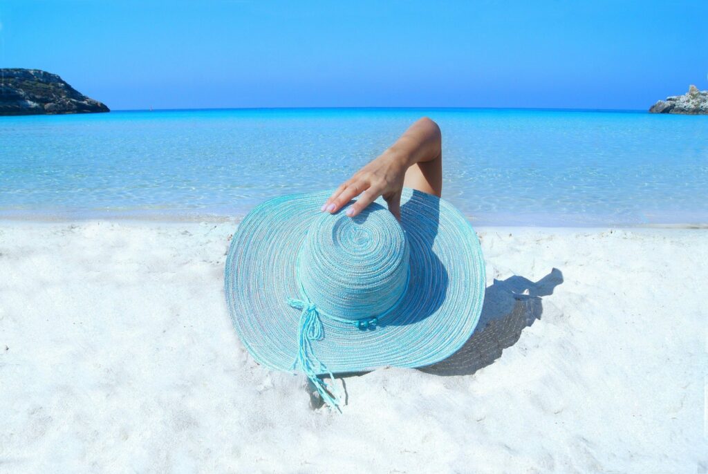 lady-with-hat-on-beach-enjoying-vacation-property-investment