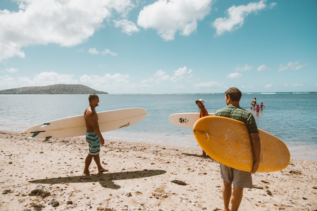 couple-guys-standing-with-surf-boards-on-beach